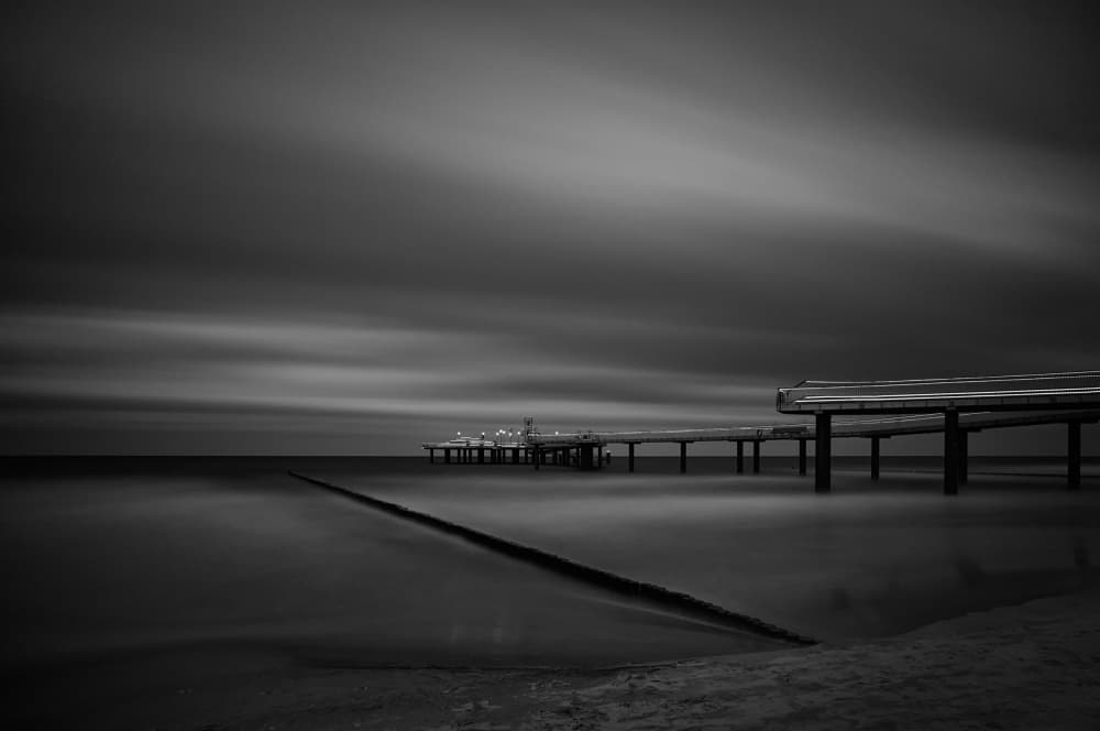 Moody Seascape Pier by Radek Pohnan — canvas wall art