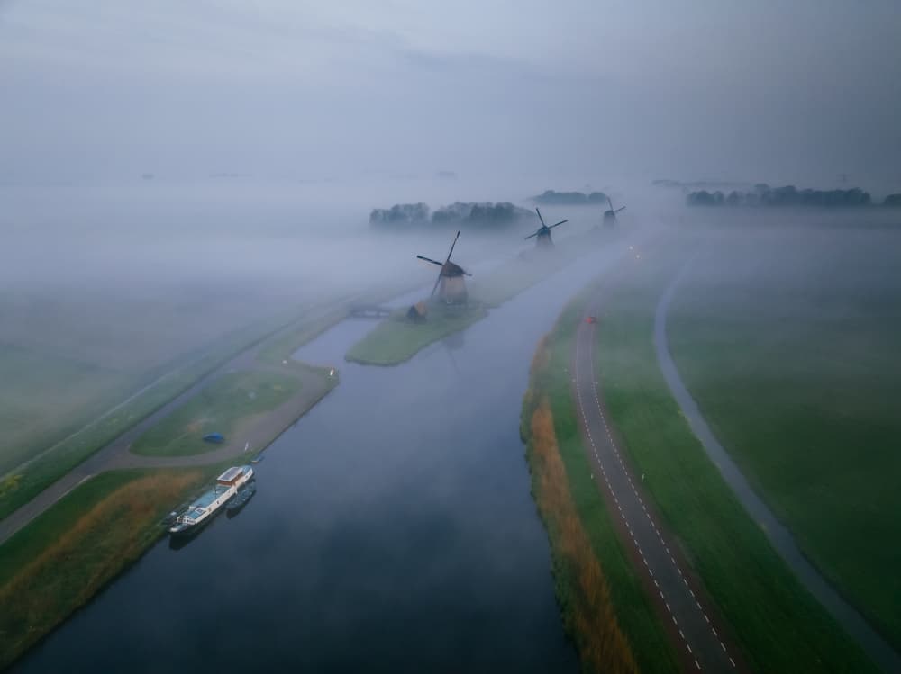 Misty Dutch Windmills by Adrian Popan — canvas wall art