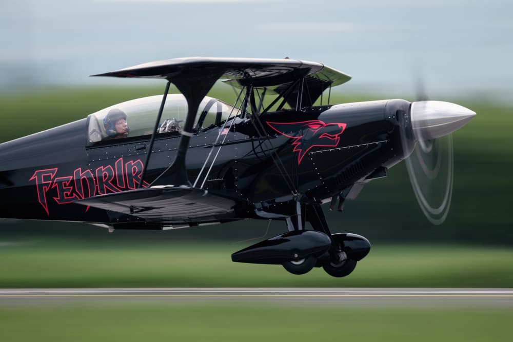Black Biplane Takes Flight by Piotr Wrobel — canvas wall art
