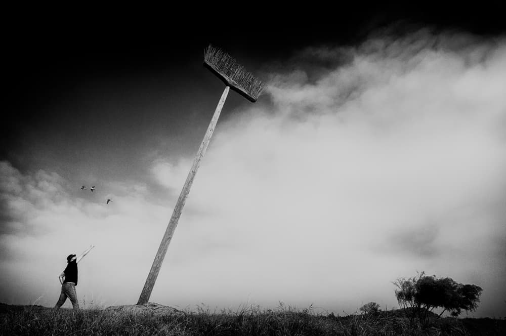 Man and Giant Broom by Miki Meir Levi — canvas wall art