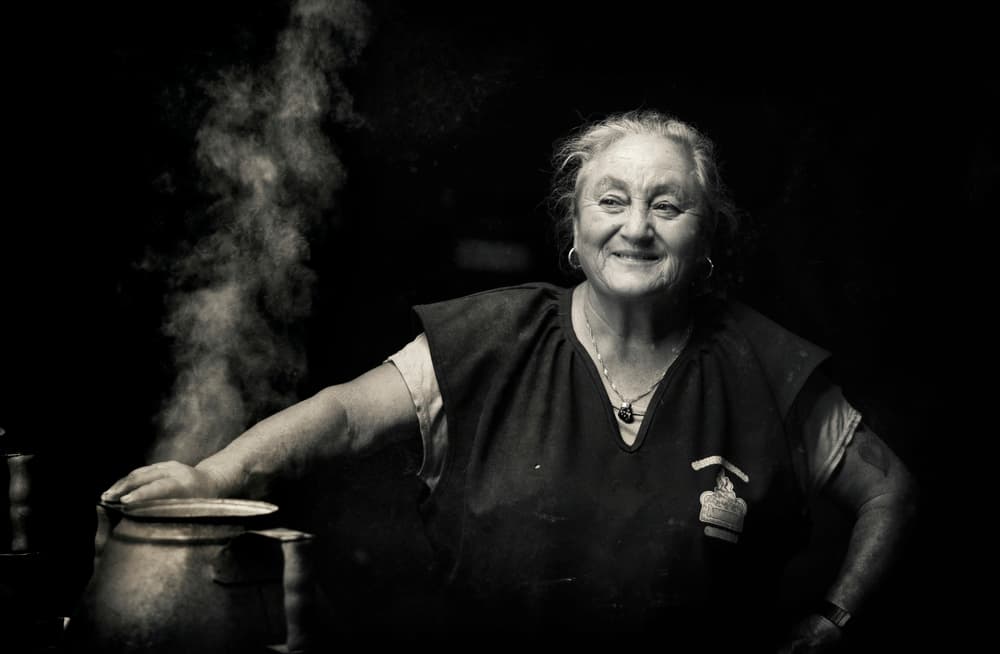 Happy Woman Cooking by Agostinho Teixeira — canvas wall art