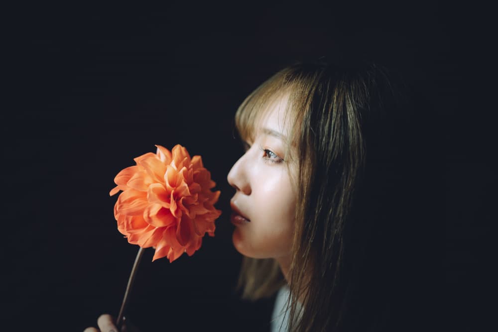 Woman Smelling Orange Dahlia by h112o1 — canvas wall art