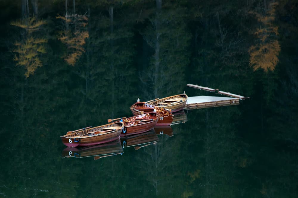 Serene Forest Lake Boats by Jrmgard Sonderer — canvas wall art