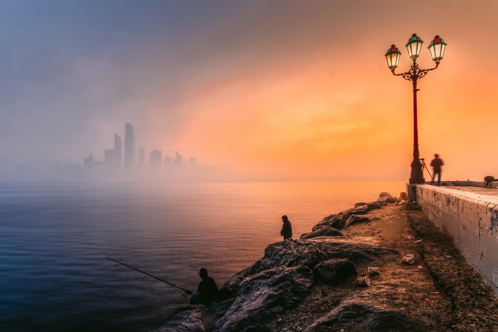 Misty Coastal City Sunrise by Mohamed Kazzaz — canvas wall art