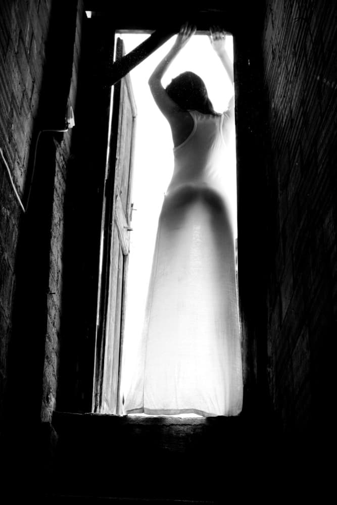 Woman in Doorway Light by Olga Mest — canvas wall art