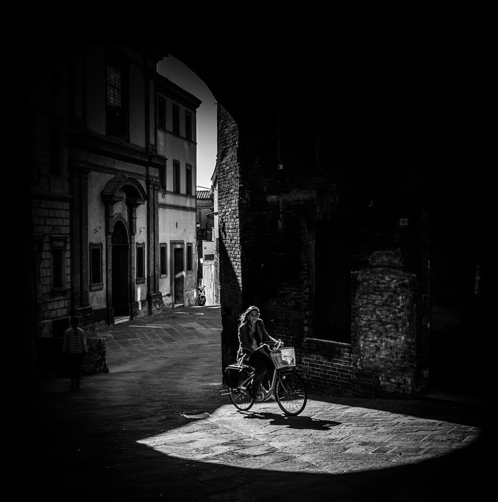 Woman Cycling Through Light by Pawel Majewski — canvas wall art