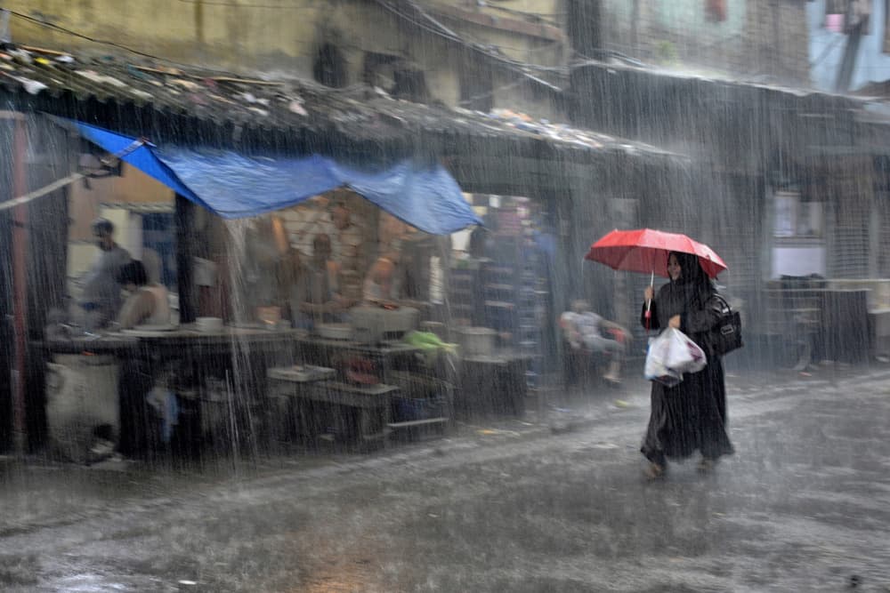 Red Umbrella Rainy Street by Shaibal Nandi — canvas wall art