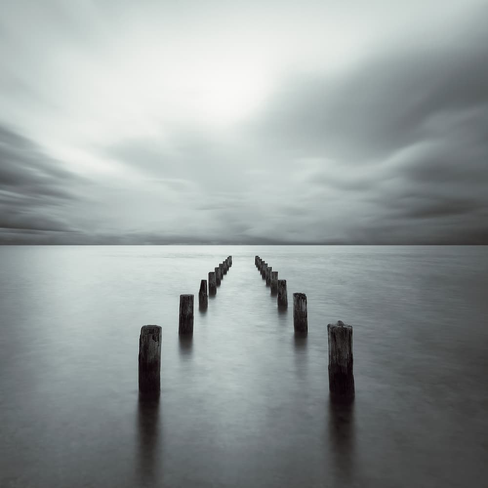 Moody Ocean Pilings by Alexej Schulz — canvas wall art
