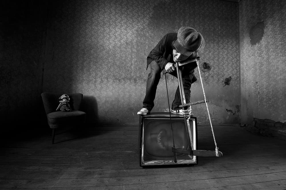 Man Sawing Television by mario grobenski - psychodaddy — canvas wall art