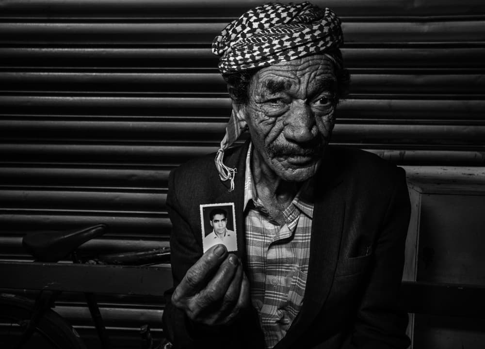 Elderly Man Holds Photo by Fadhel Almutaghawi — canvas wall art