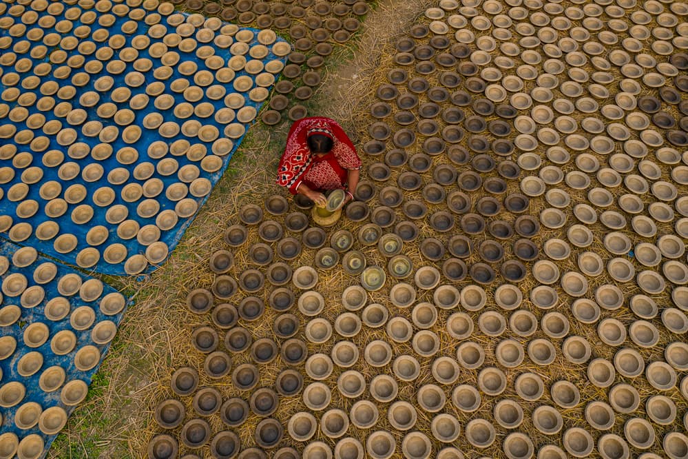 Artisan Drying Clay Pots by Azim Khan Ronnie — canvas wall art
