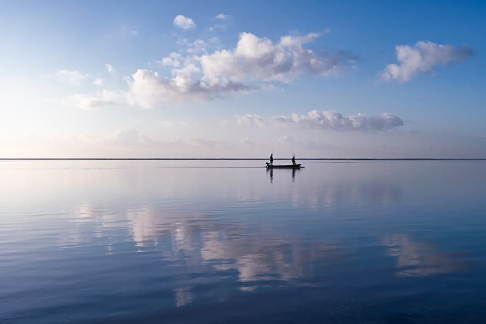 Serene Boat Reflections by Gerald Macua — canvas wall art