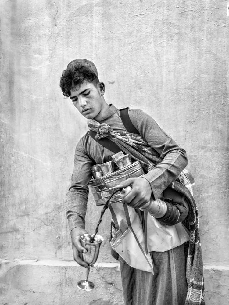 Young Man Pouring Coffee by Bashar Alsofey — canvas wall art