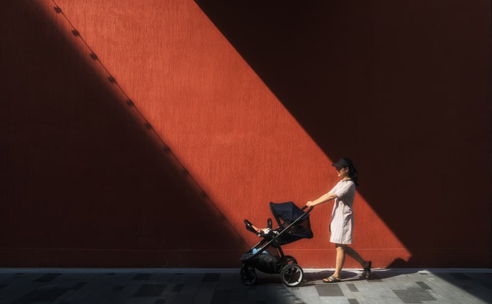 Red Wall Sunlight Stroll by Ke Liu — canvas wall art