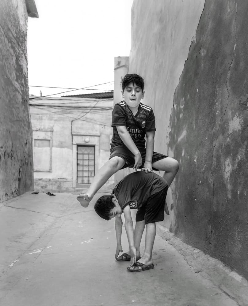 Boys Playing Leapfrog by Bashar Alsofey — canvas wall art