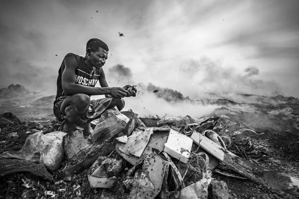 Man Sifting Through Trash by João Coelho — canvas wall art
