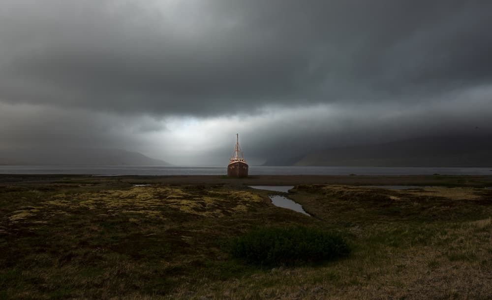 Weathered Boat Under Clouds by Erik Engström — canvas wall art