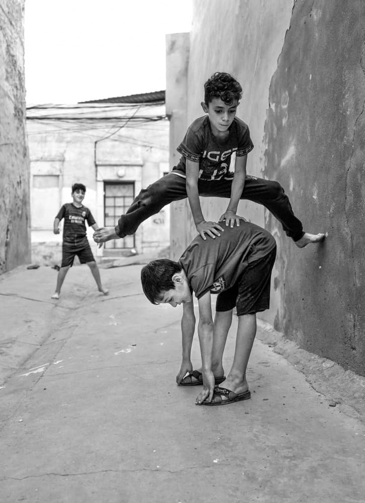 Street Play Jump by Bashar Alsofey — canvas wall art