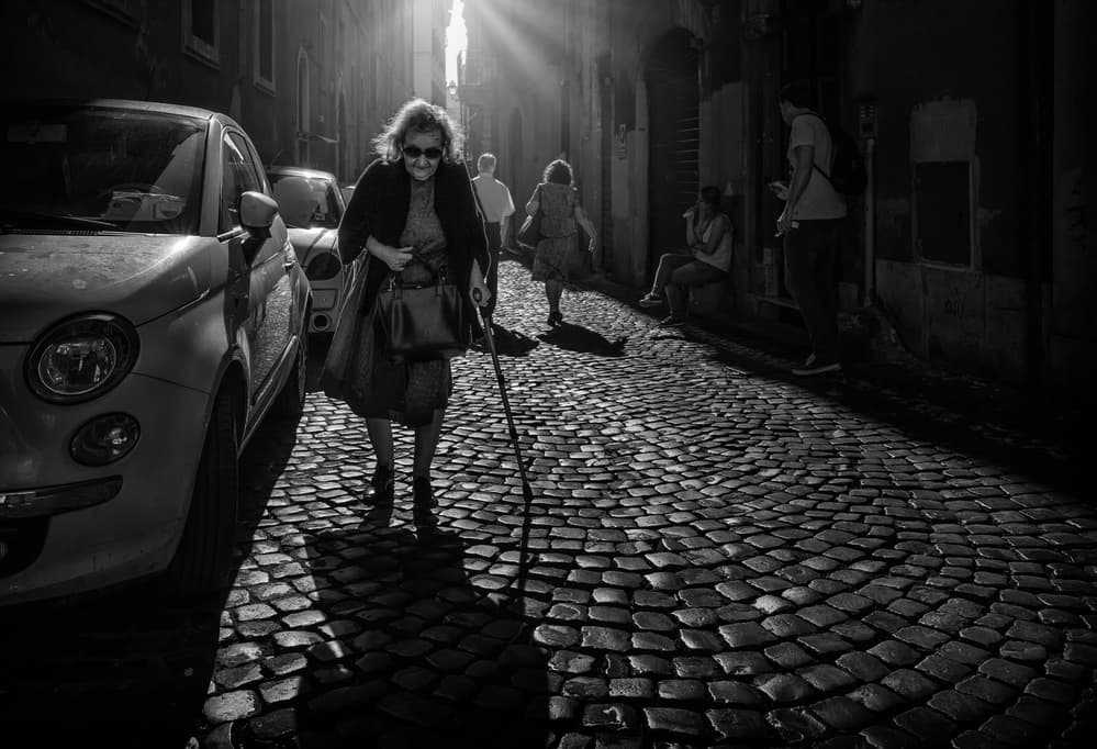 Old Woman's Sunlit Walk by Massimiliano Mancini — canvas wall art