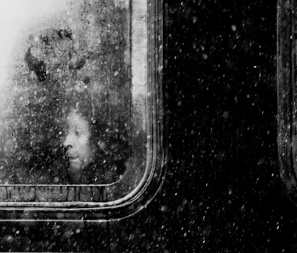 Pensive Woman Snowy Window by Jian Wang — canvas wall art