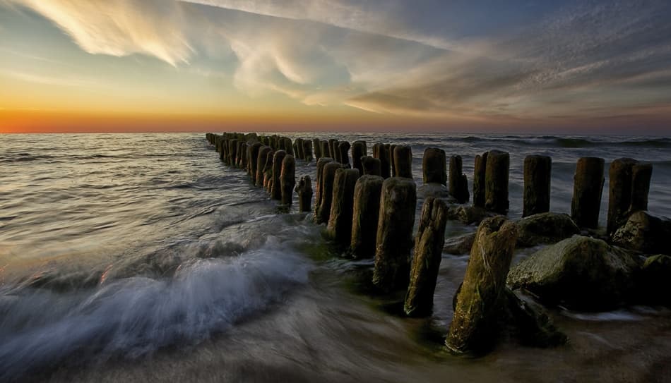 Coastal Sunset Groynes by Margarita Chernilova — canvas wall art