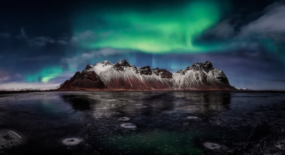Green Aurora Mountain Reflection by Javier de la Torre — canvas wall art