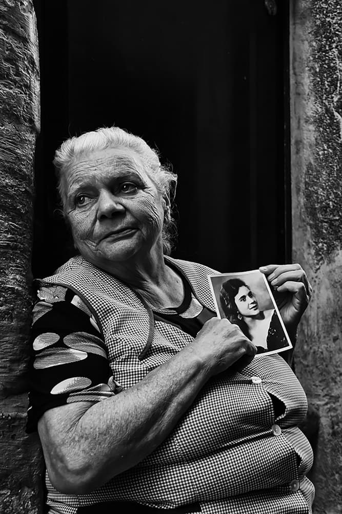 Elderly Woman Holding Photo by Josefina Melo — canvas wall art