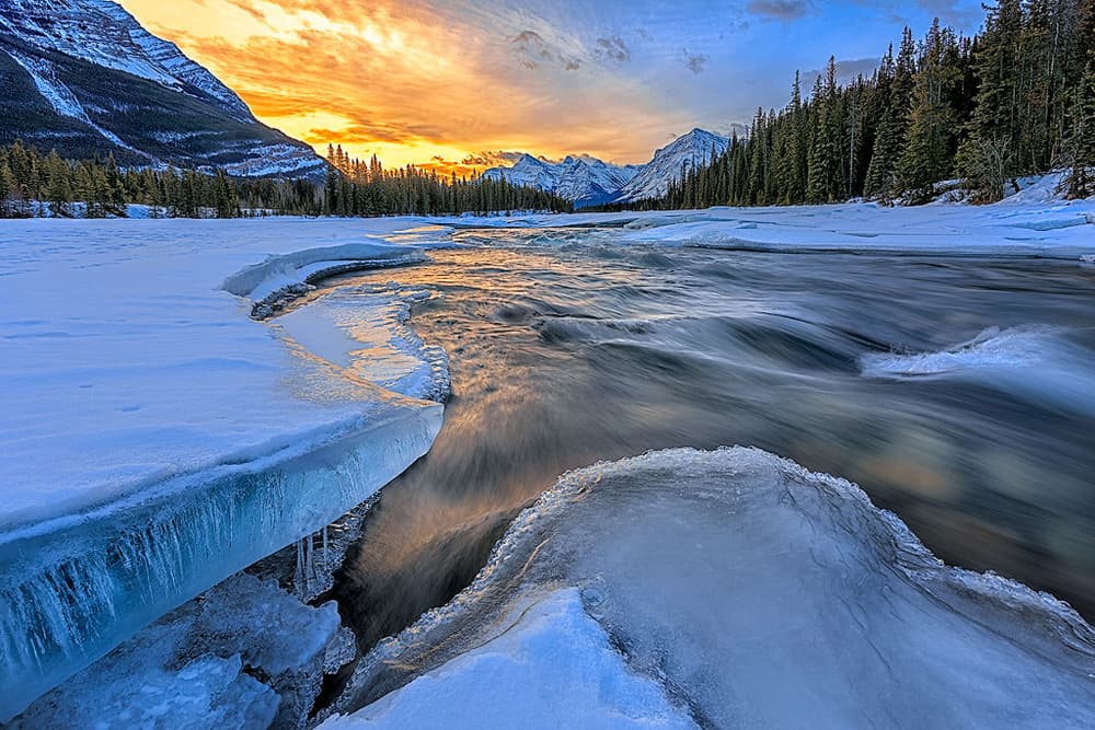 Vibrant Winter River Sunset by Yimei Sun — canvas wall art