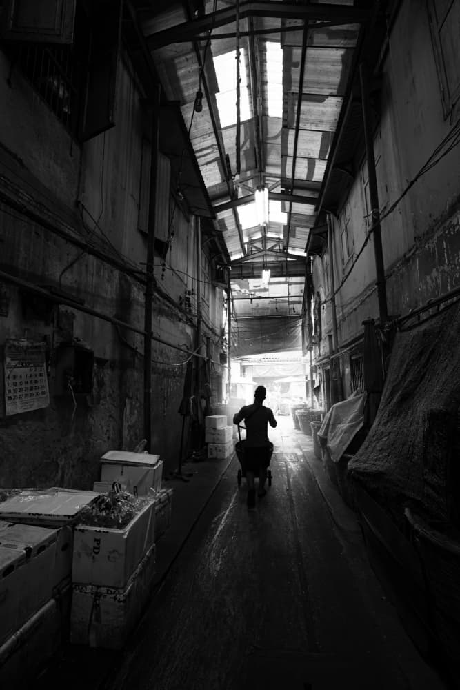 Worker in Alley Light by Anuchit Sundarakiti — canvas wall art
