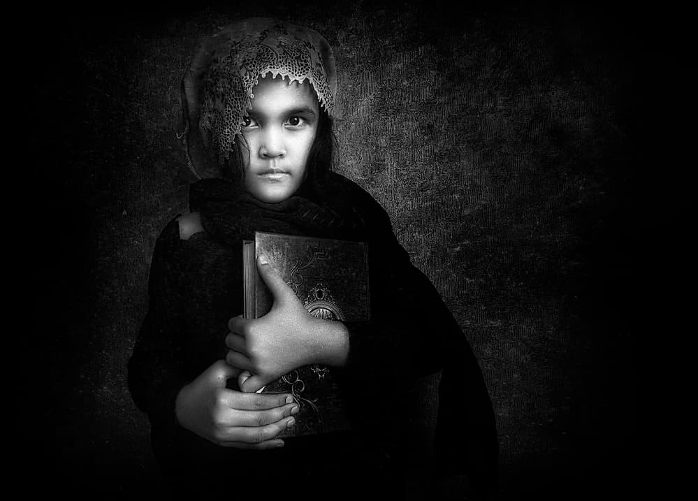 Solemn Girl with Book by Arief Siswandhono — canvas wall art