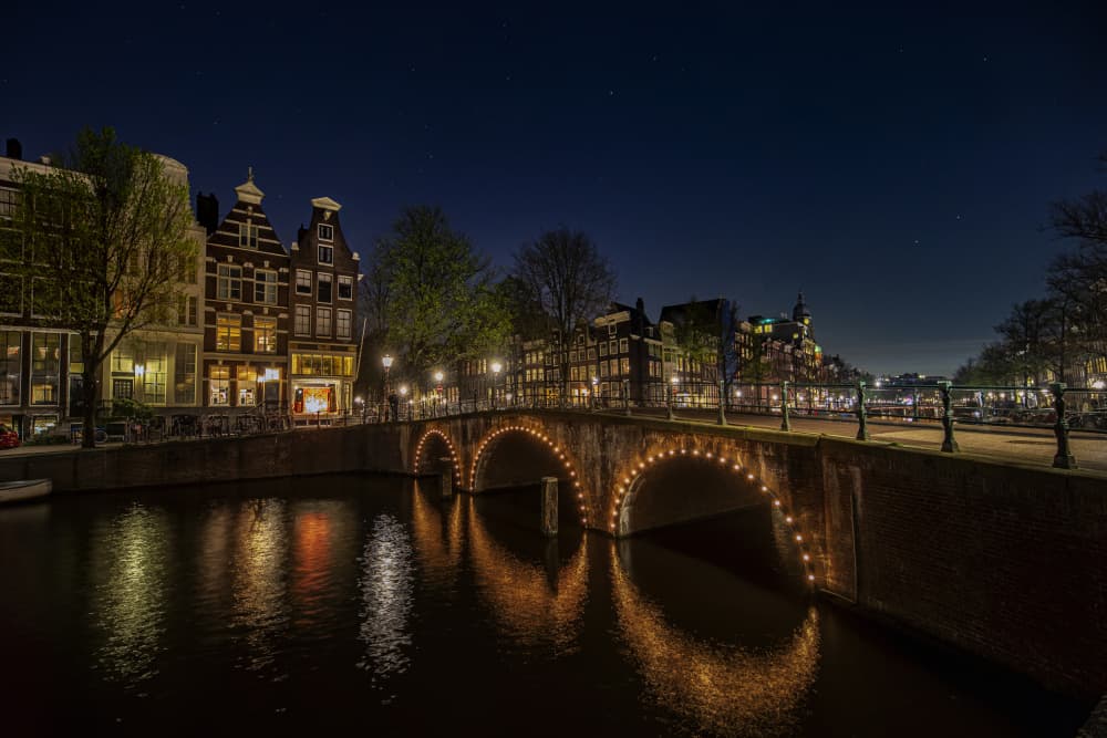 Amsterdam Canal Bridge Night by JUAN CARLOS HERVÁS MARTÍNEZ — canvas wall art