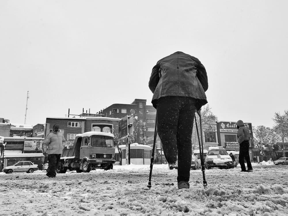 Man On Crutches In Snow by Shamal Shakibayi — canvas wall art