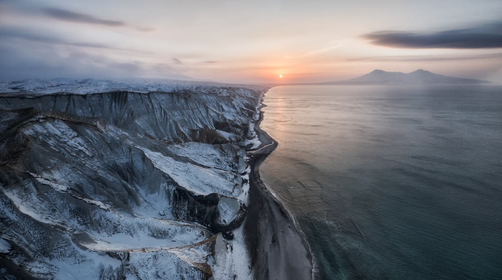 Snowy Coastal Sunset by Ivan A. Godovikov — canvas wall art
