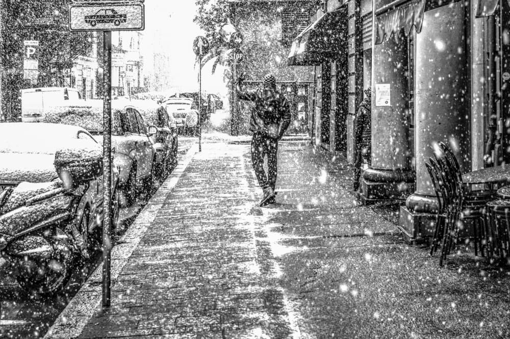 Man Walking Snowy Street by Alessandro Traverso — canvas wall art