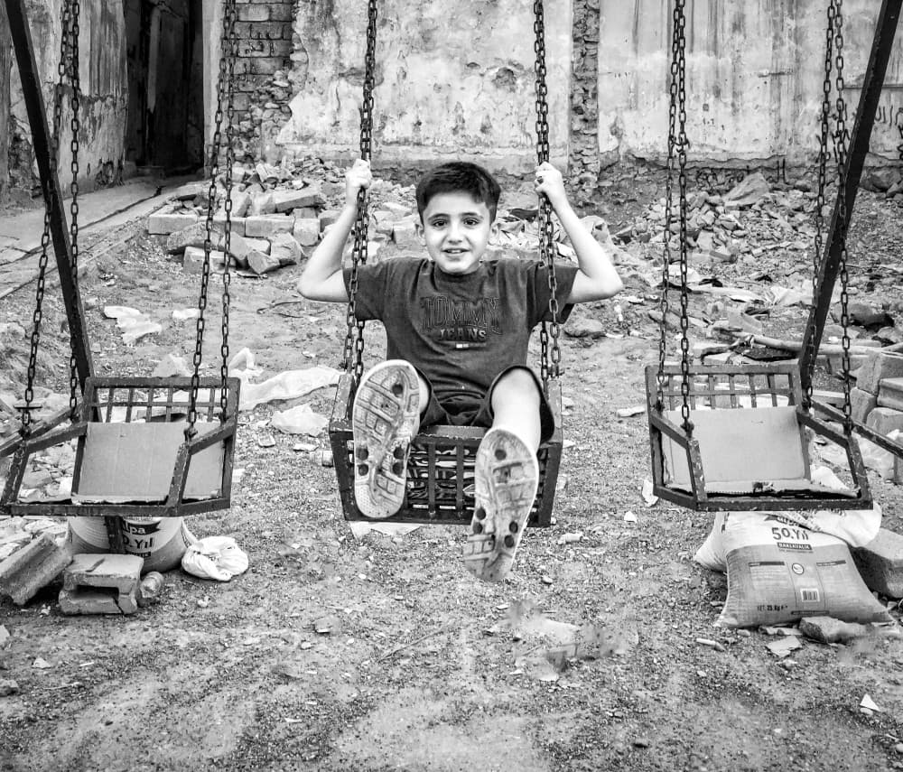 Happy Boy Swinging by Bashar Alsofey — canvas wall art