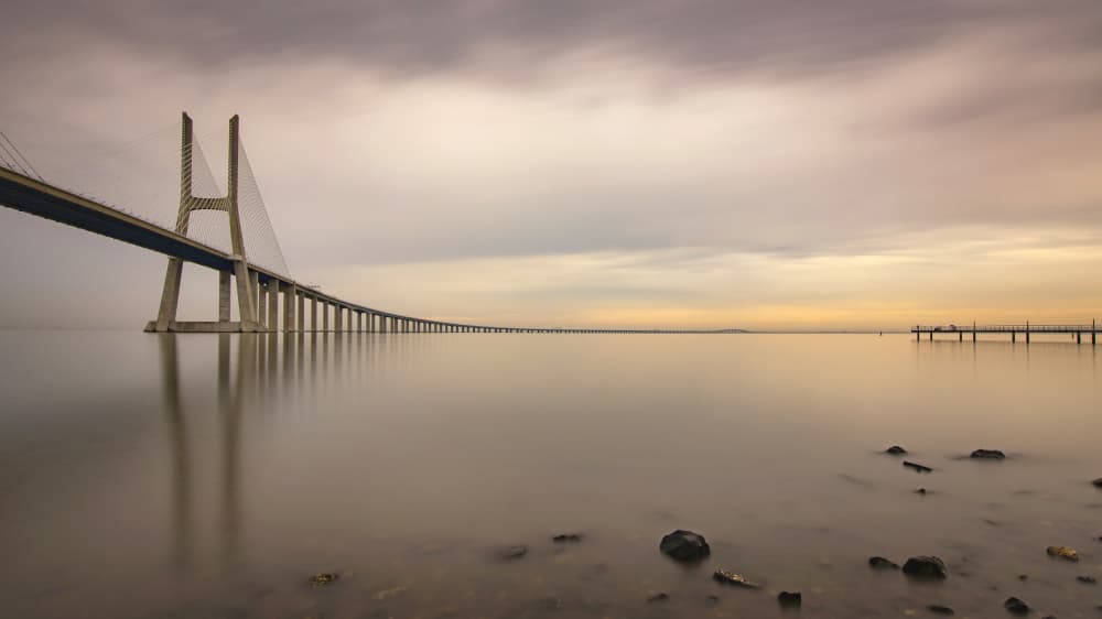 Serene Bridge Reflection by JUAN CARLOS HERVÁS MARTÍNEZ — canvas wall art