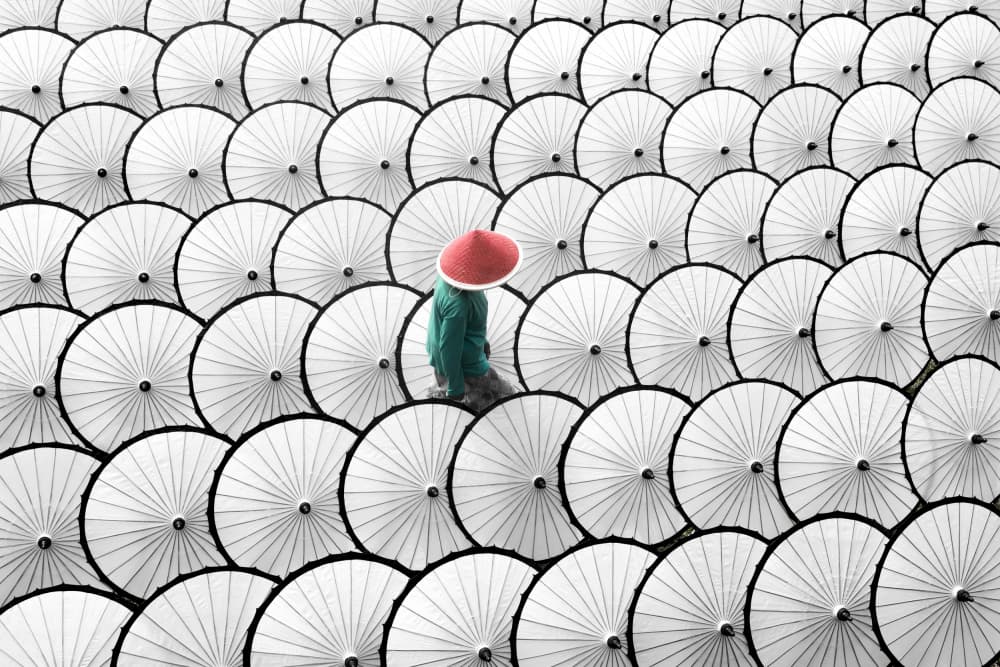 Red Hat Among Umbrellas by Gatot Herliyanto — canvas wall art