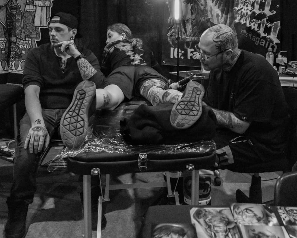 Tattoo Artist At Work by Wendy Fischer Hartman — canvas wall art