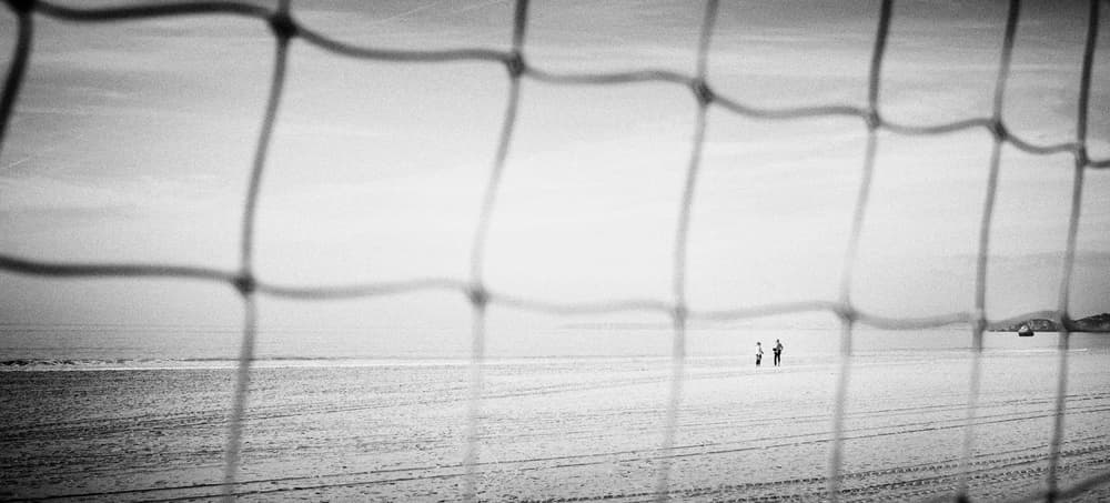 Beach Net Distant People by Nuno Borges — canvas wall art