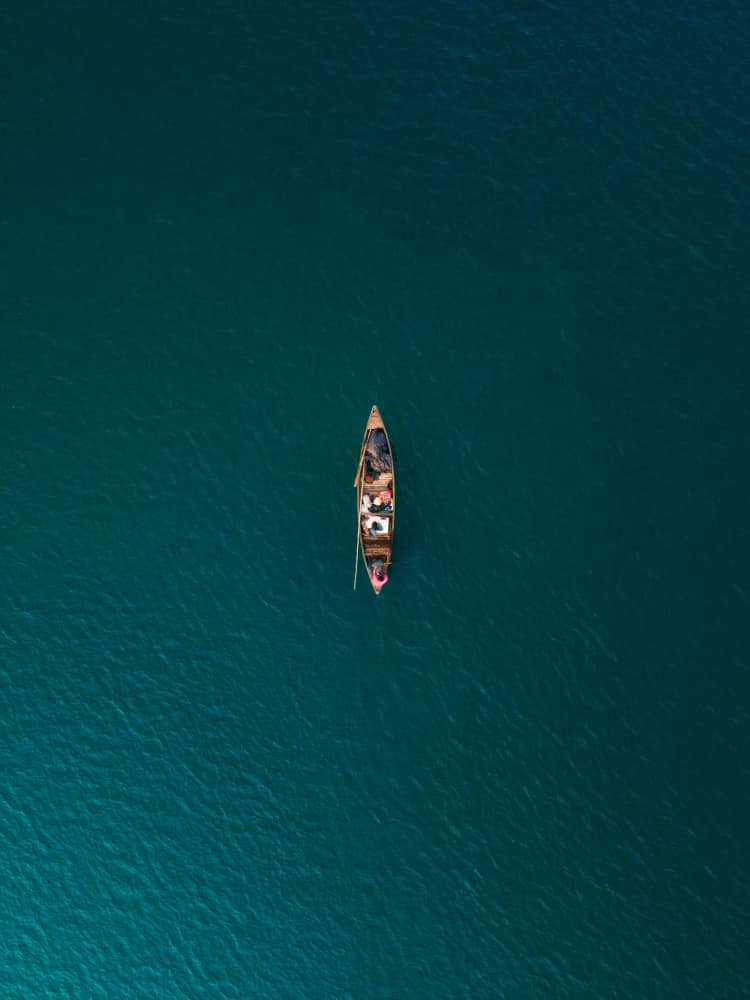 Lone Boat on Teal Water by Partha Pritam Mahanta — canvas wall art