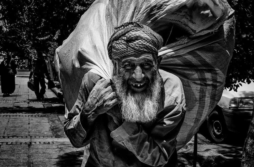 Smiling Man's Burden by Joxe Inazio Kuesta Garmendia — canvas wall art