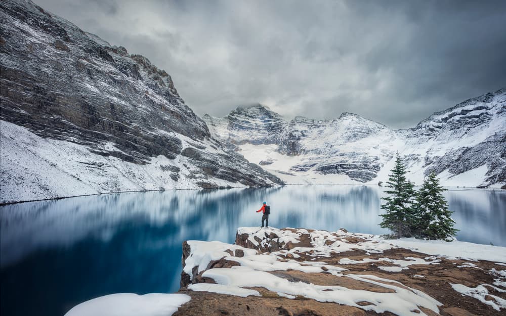 Hiker At Snowy Lake by Michael Zheng — canvas wall art