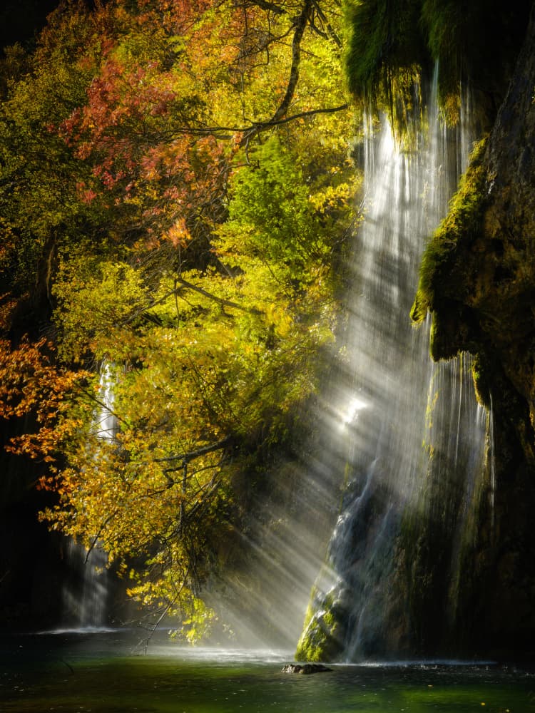 Sunlit Autumn Waterfall by Stefan Gunnarsson — canvas wall art