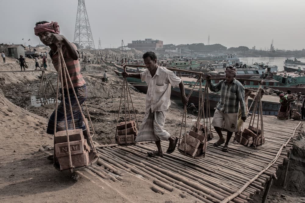 Manual Laborers Carrying Bricks by Joxe Inazio Kuesta Garmendia — canvas wall art