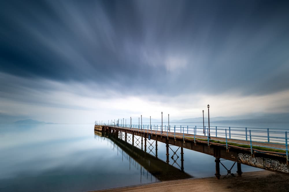 Pier Over Tranquil Water by George Digalakis — canvas wall art