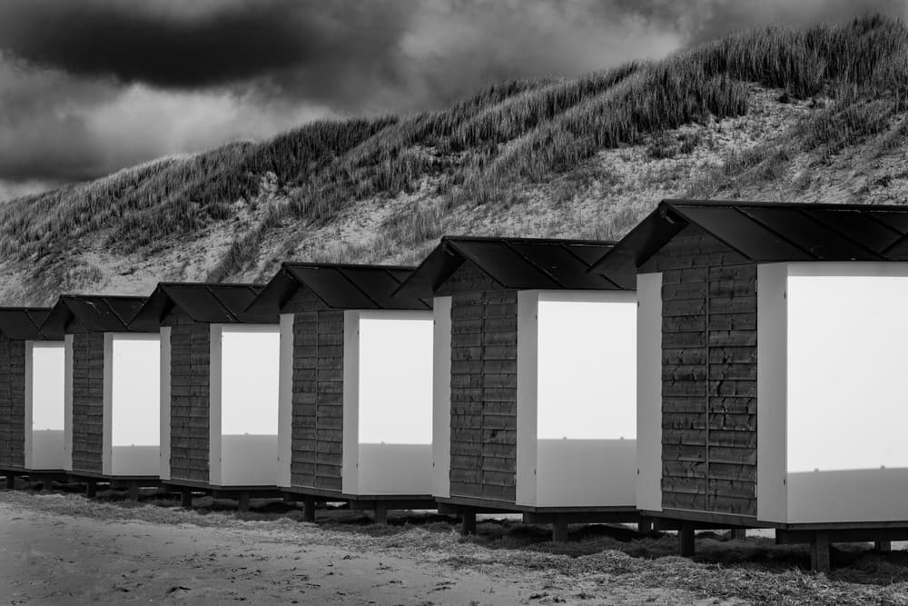 Monochrome Coastal Huts by Andy Bauer — canvas wall art