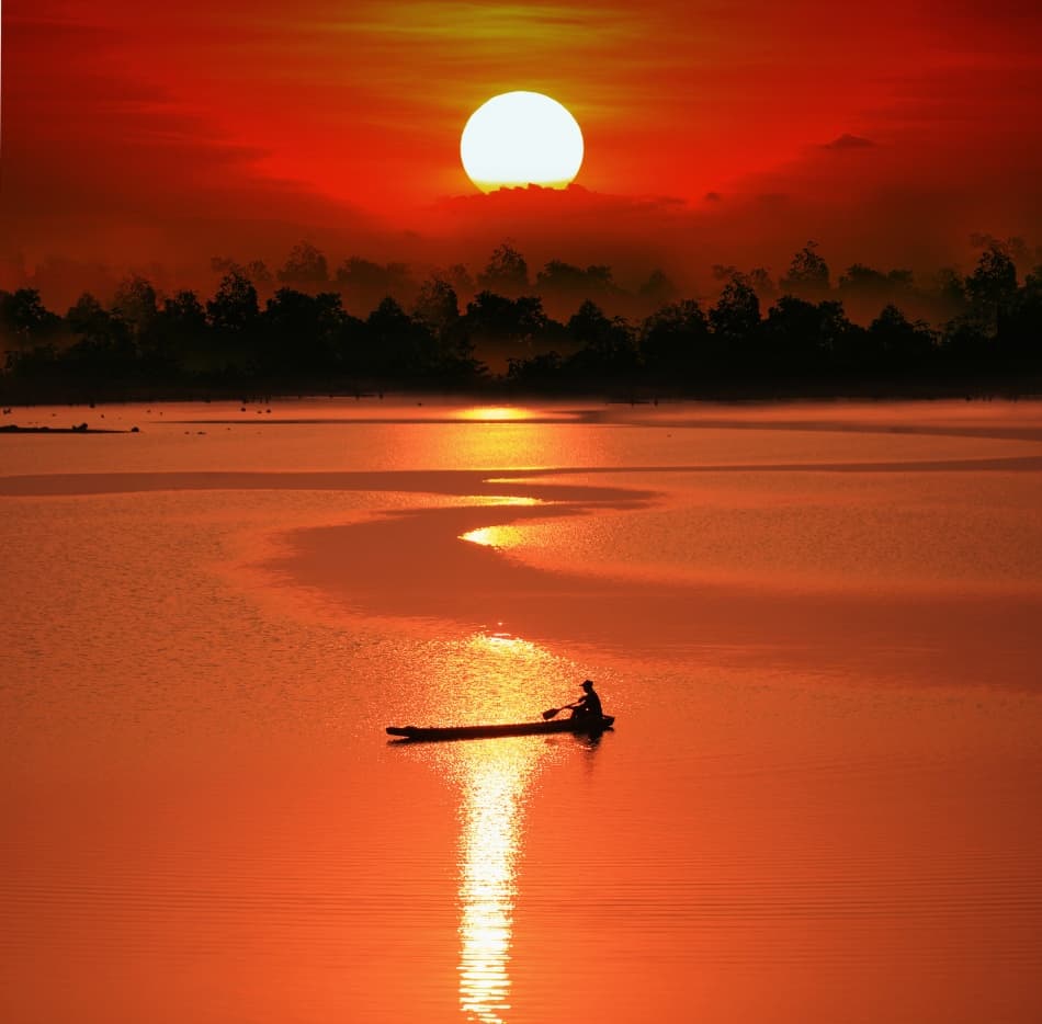 Vibrant Sunset Boat Reflection by Sarawut Intarob — canvas wall art