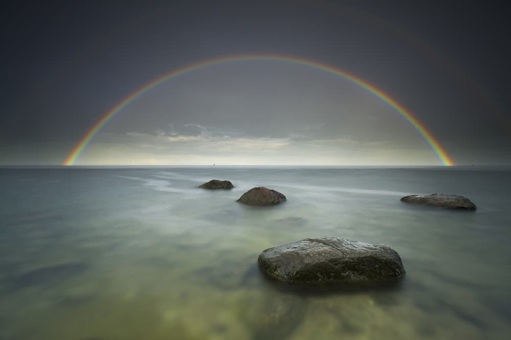 Rainbow Ocean Rocks by Karol Nienartowicz — canvas wall art