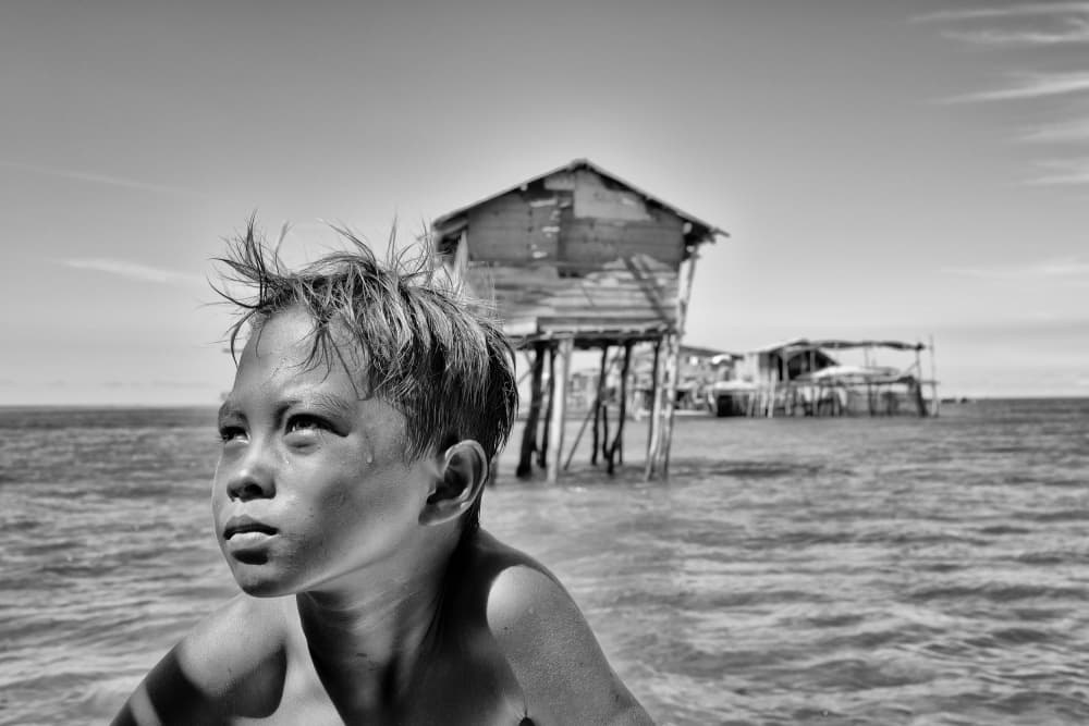Thoughtful Boy by the Sea by Kieron Long — canvas wall art