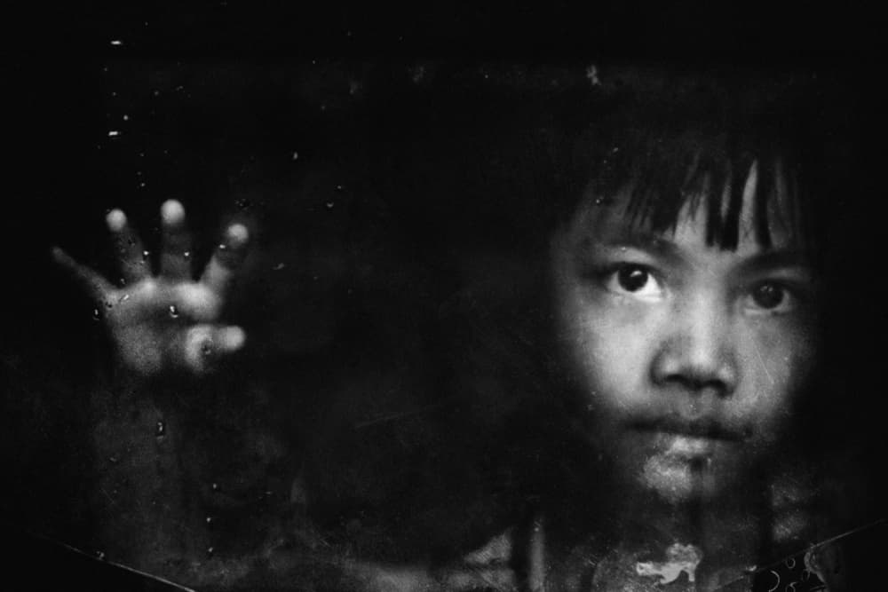 Pensive Child Through Glass by Jay Satriani — canvas wall art